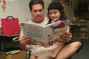 Father and daughter reading Abuela