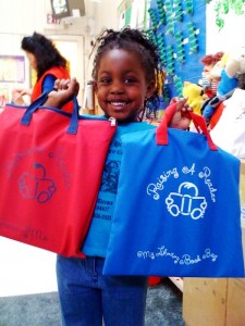 African American girl holding blue and red bags